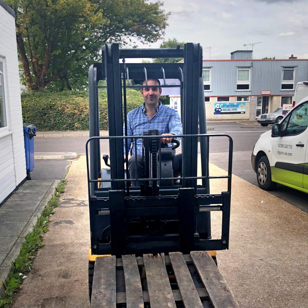 Salt of the Earth Thomas Laird driving a forklift outside warehouse as part of daily operations